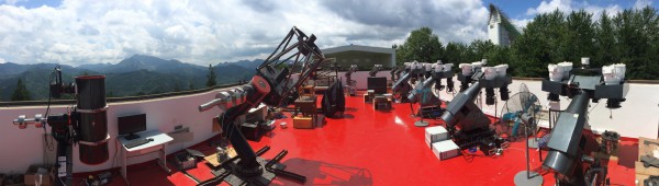 Panoramic view of GWAC installation at Xinglong Observatory (Beijing, China) showing 4 GWAC mountings (right) and 60cm and 30cm telescopes (left). @NAOC 